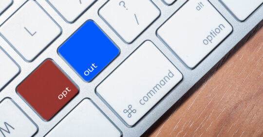 red and blue opt out buttons on white computer keyboard