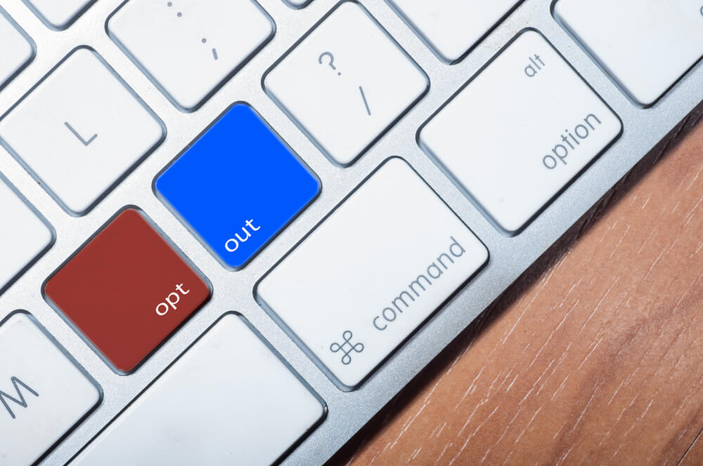 red and blue opt out buttons on white computer keyboard