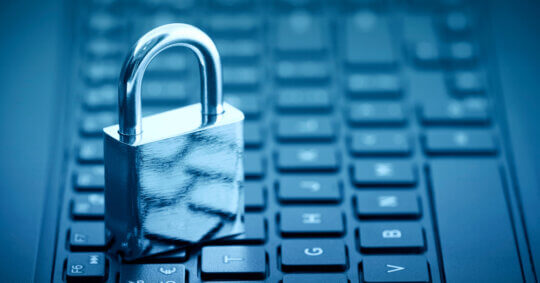 padlock on computer keyboard with blue tone