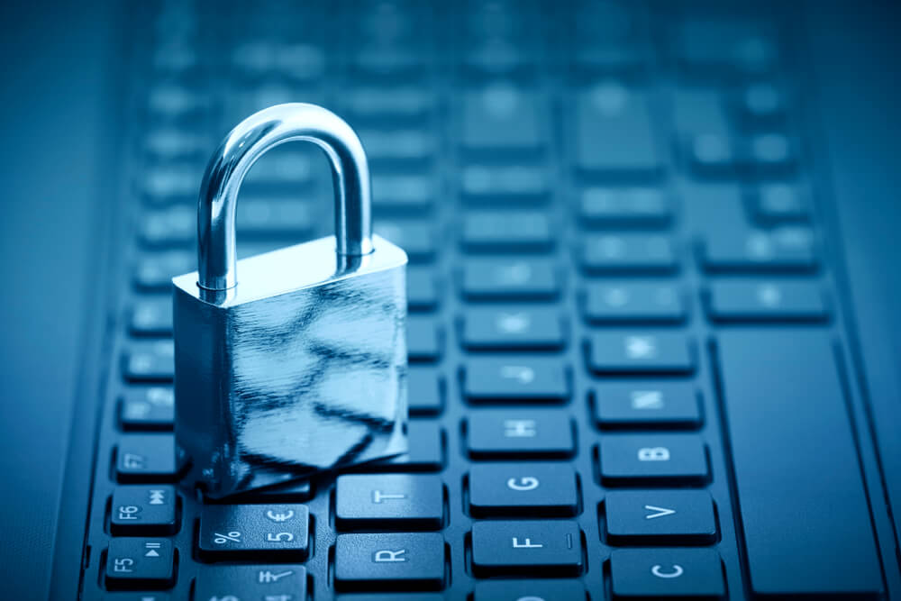 padlock on computer keyboard with blue tone