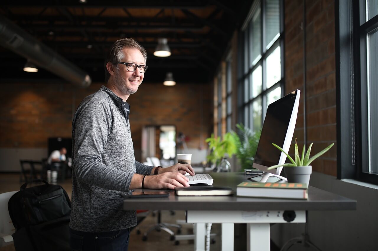 man on laptop at desk performing spydialer opt out