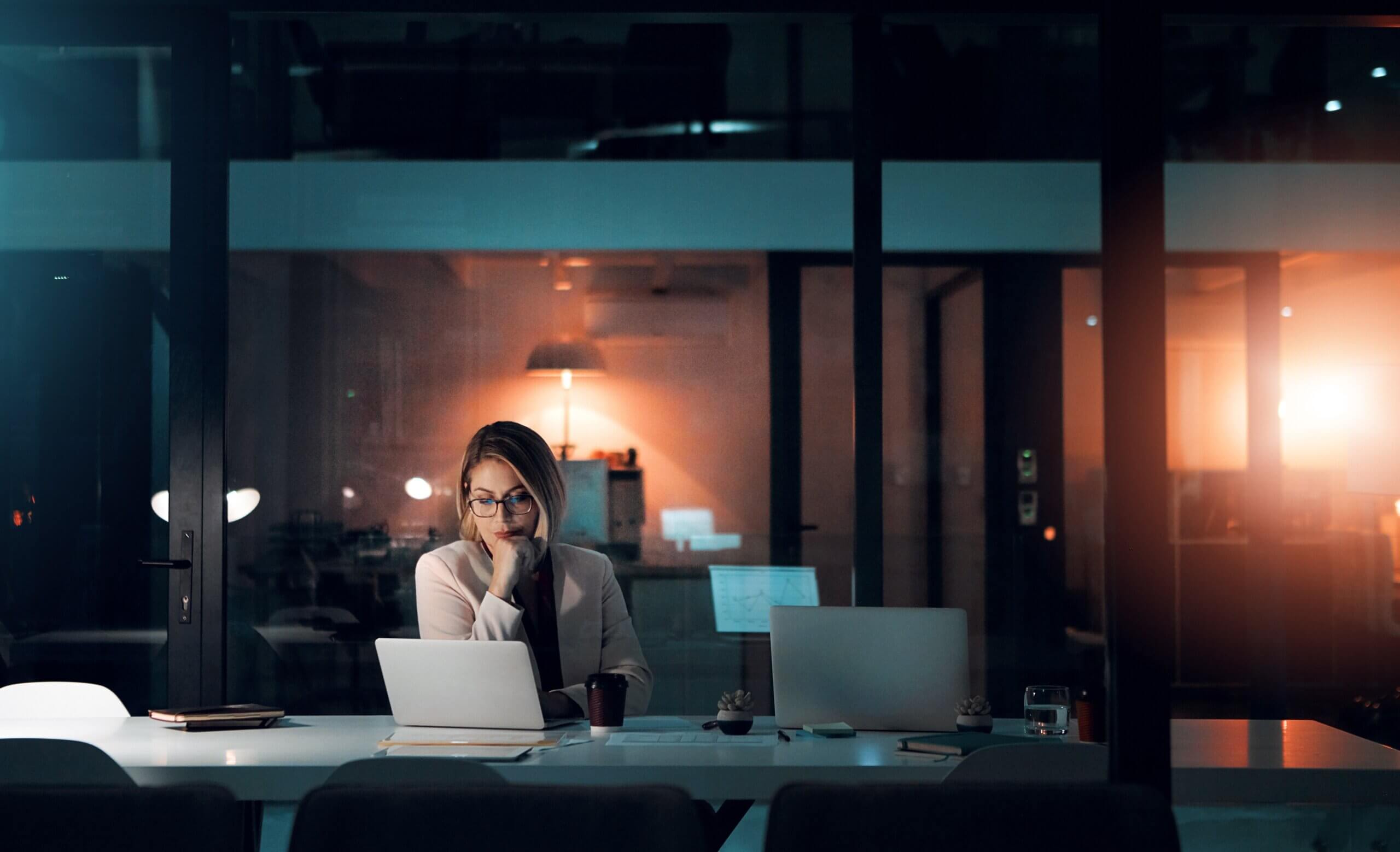 A woman learns about the Instant Checkmate opt out process on a laptop in the evening.