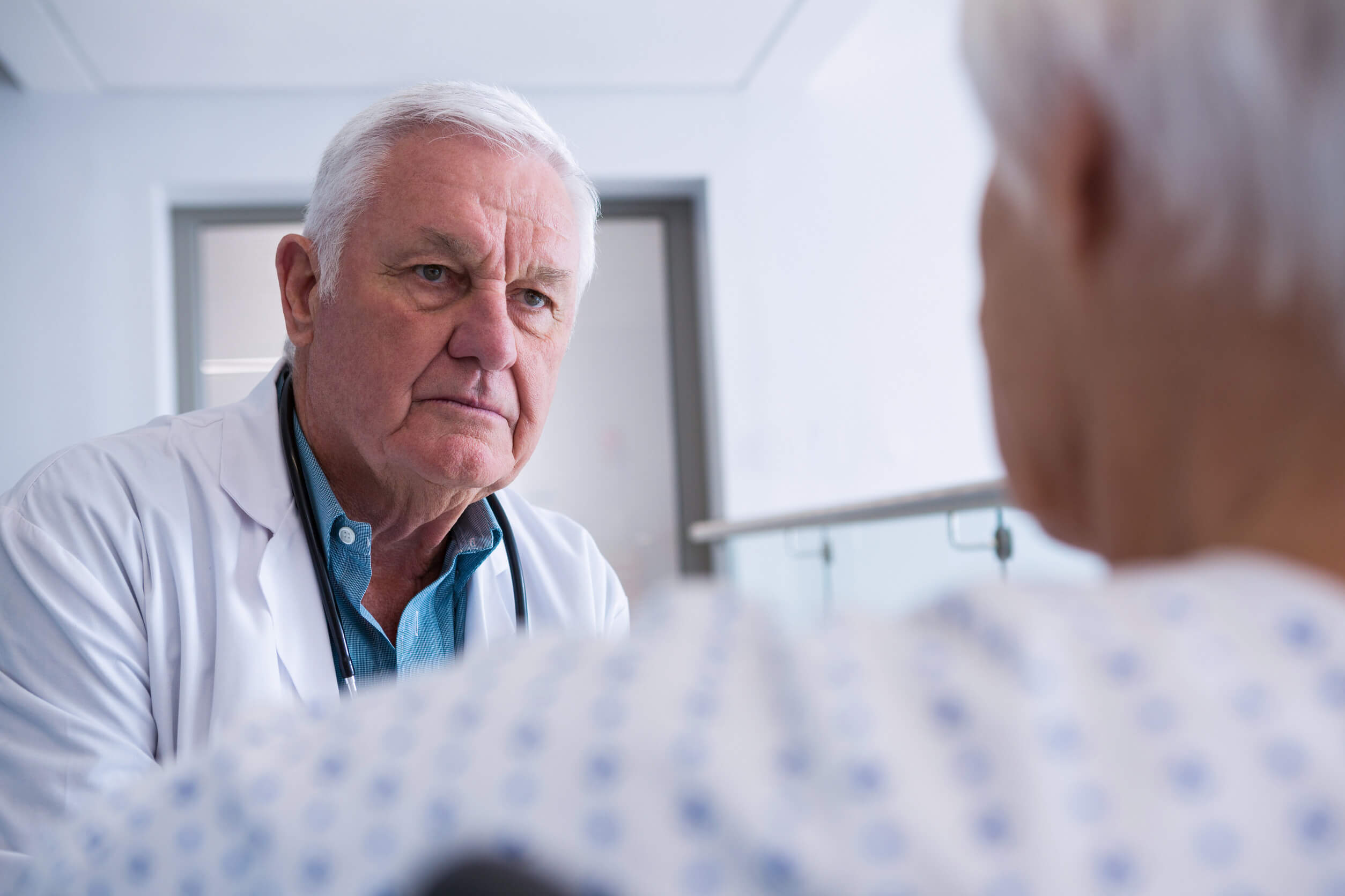 Older man and doctor discussing Medicare opt outs.