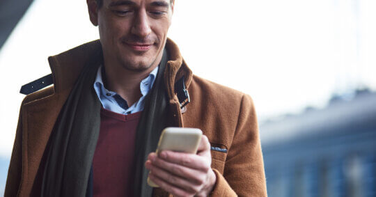 A man using his phone to complete the Discord opt out process.