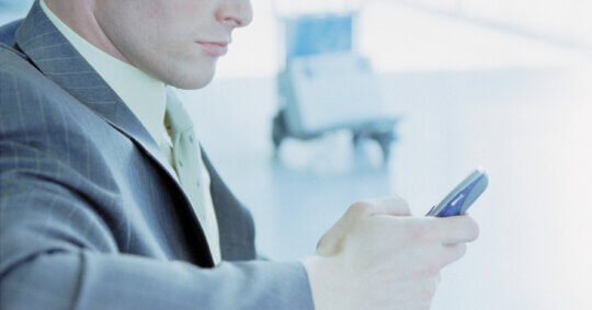 A man using his phone to learn how the Experian opt out process works.