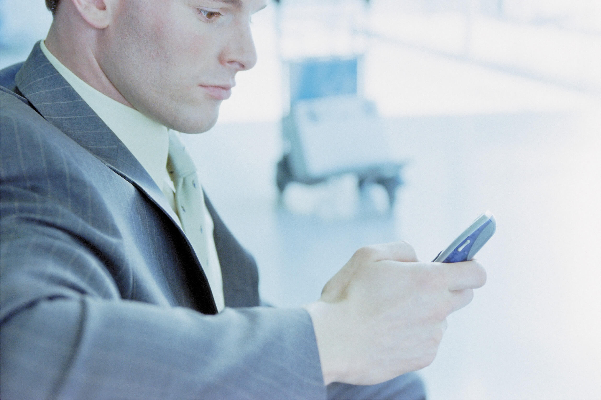 A man using his phone to learn how the Experian opt out process works.