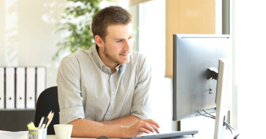 A man using his computer to learn how the ClustrMaps opt out process works.