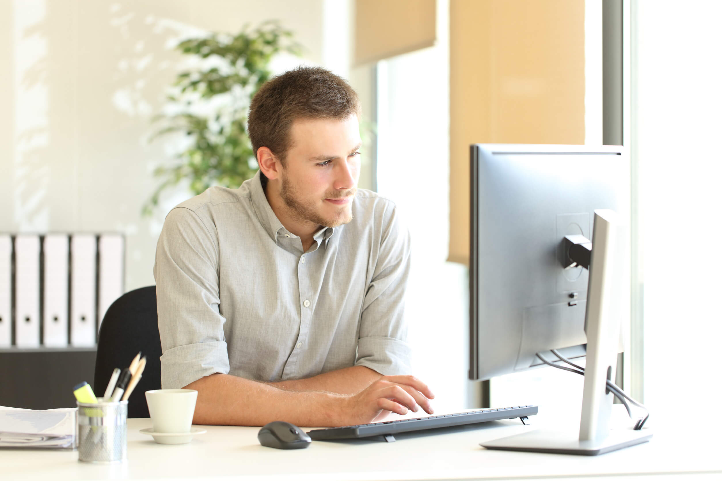 A man using his computer to learn how the ClustrMaps opt out process works.