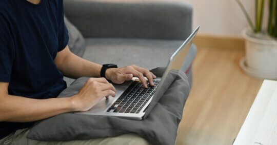 A person using a laptop at home while completing a MyLife opt out request.