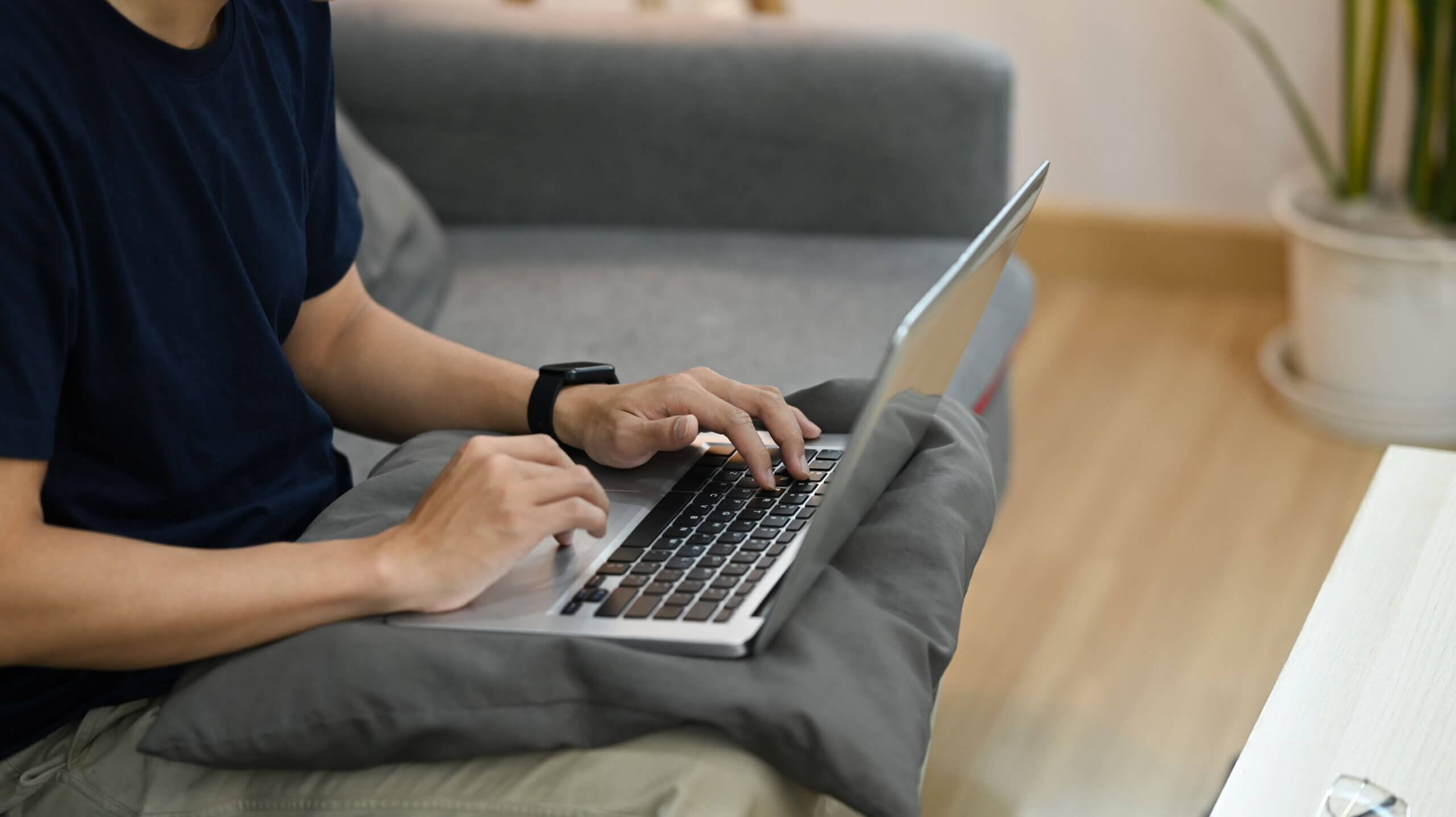 A person using a laptop at home while completing a MyLife opt out request.