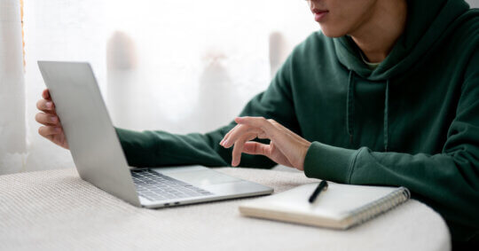 A person researching the ChexSystems opt out process on a laptop at home.