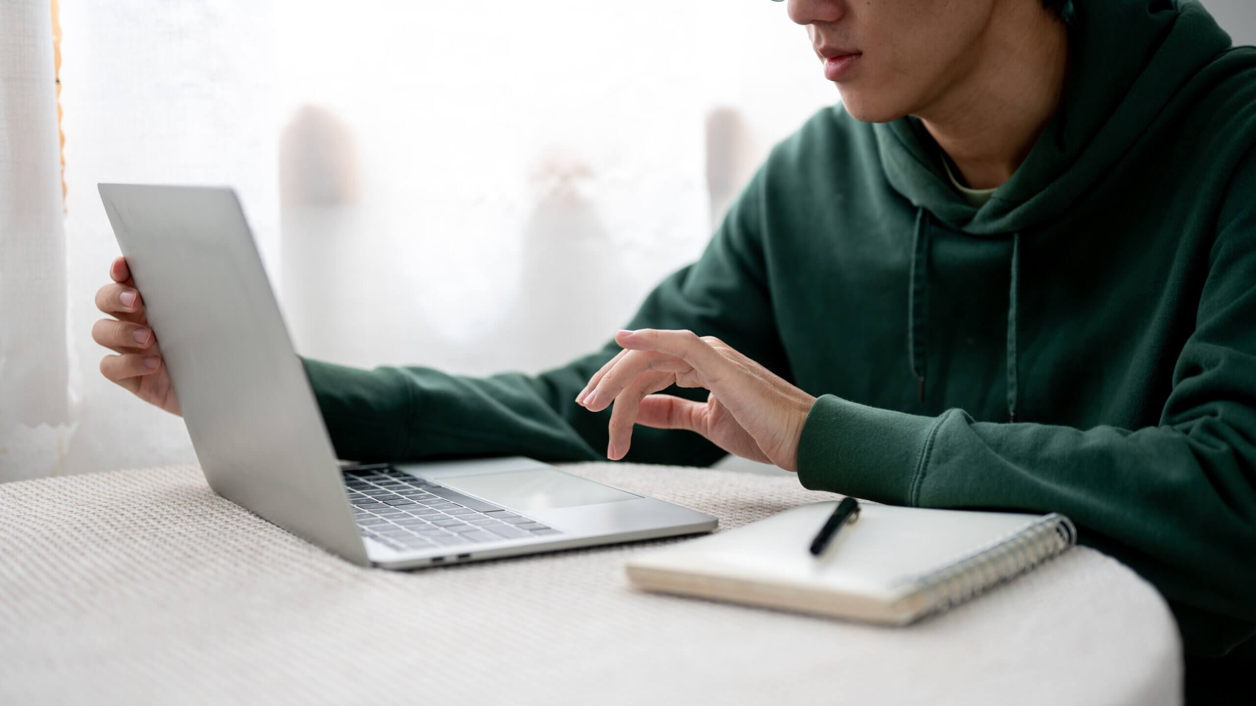 A person researching the ChexSystems opt out process on a laptop at home.