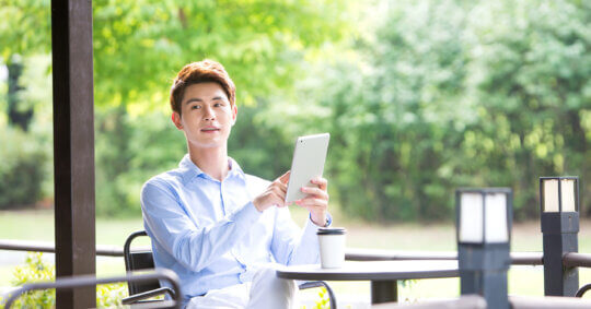A man using a tablet outside after learning about the OfficialUSA opt out process.